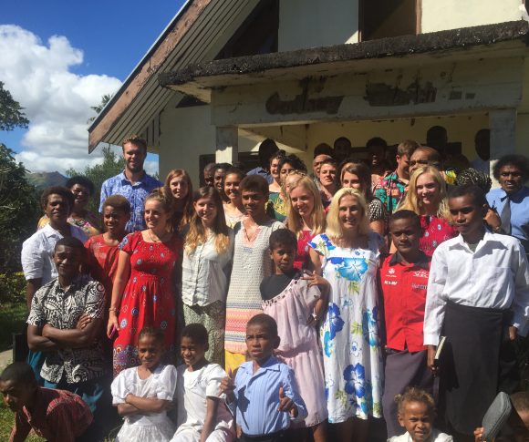 Team and villagers outside church